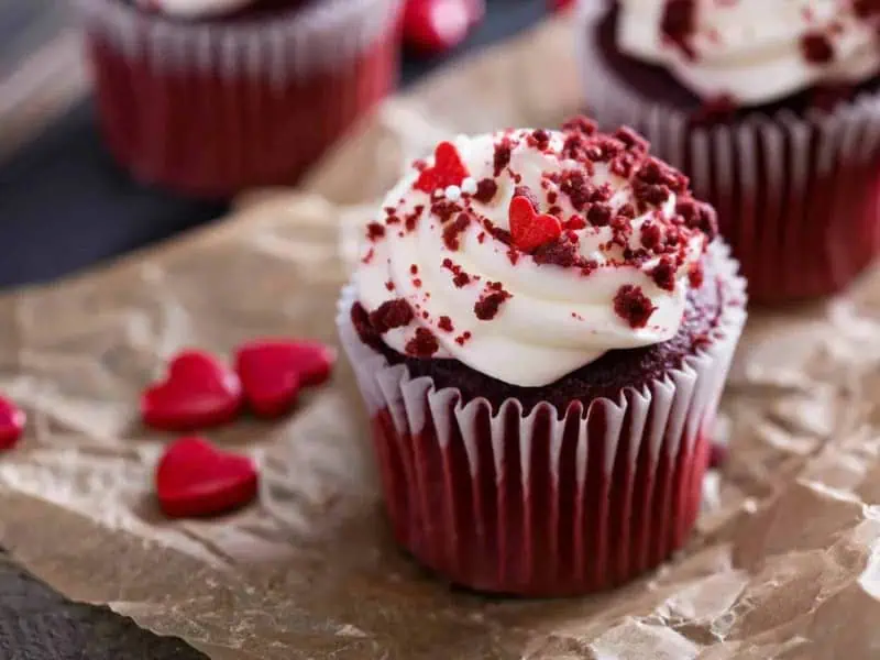 image 247 206 - Step aside, store-bought cupcakes! These Red Velvet Cupcakes are way better than anything you'll find at the store. Whip up these perfectly rich confections to celebrate any occasion, even if that occasion is just getting through another weekday! Each bite into these cupcakes is delectable: they’re moist, sweet, and chocolatey. The icing on the cake (pun intended) is that they’re topped with a delicious cream cheese frosting! Red Velvet Cupcakes are a dream dessert, and you’ll want to make them again and again.