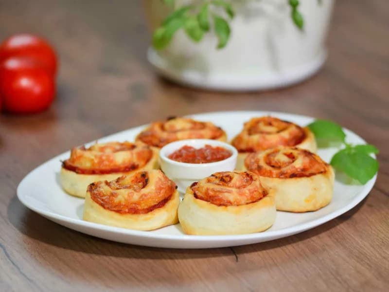 image 247 218 - These Easy Pizza Pinwheels have all the delicious flavors of pizza and are a breeze to whip up! Plus, you can tailor them perfectly to your preferences with custom toppings. Each bite is full of fresh marinara sauce, melty cheese, perfectly toasted pizza dough, and any veggies or meats you want! Skip the trip to the pizza parlor and make these Easy Pizza Pinwheels for a new, fun way to enjoy your favorite Italian flavors!