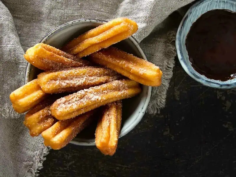 image 247 247 - Homemade Churros are irresistible confections. Let’s face it: there's nothing better than crispy fried dough covered in cinnamon sugar! These treats are the perfect finale to any Mexican dinner recipe, or you can even have them as a sweet snack. Pro tip: dip the Homemade Churros in melted chocolate for extra deliciousness!