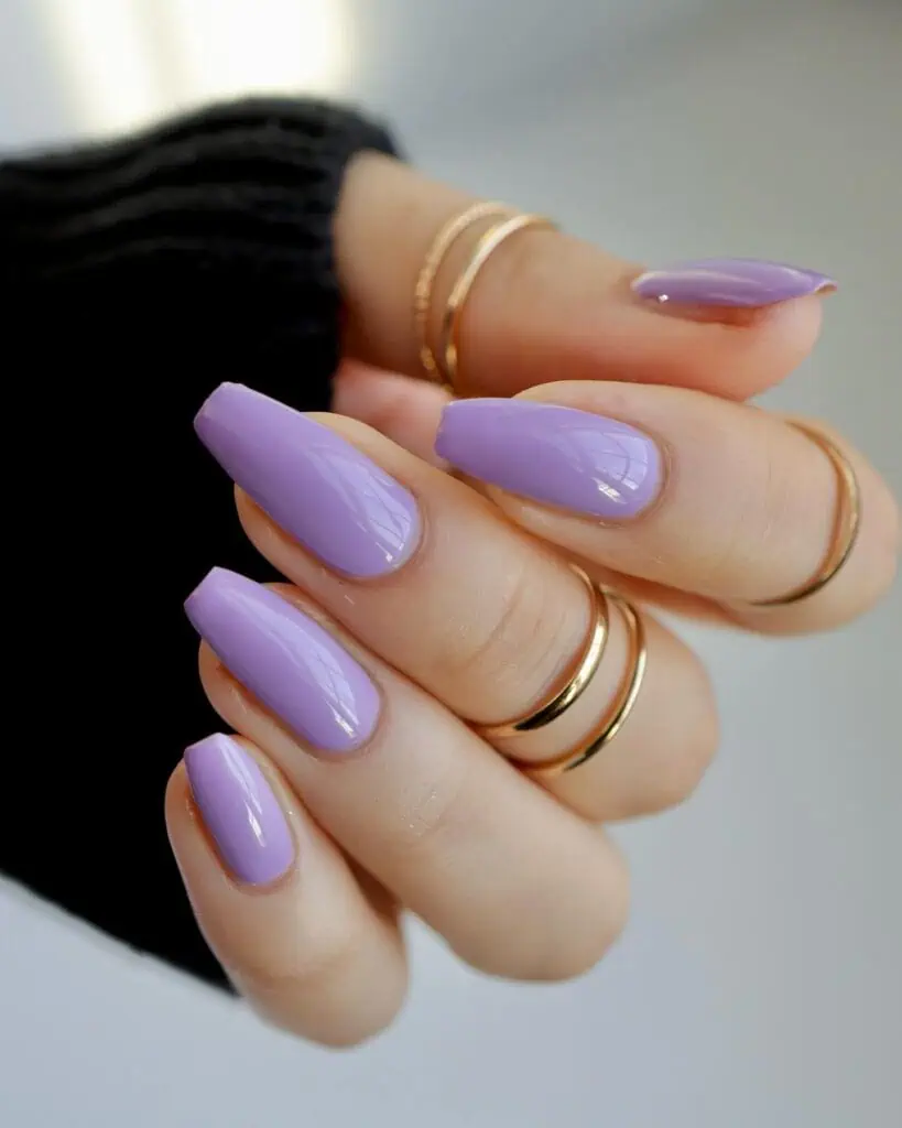 A captivating array of purple nails, featuring a spectrum of shades from soft lilac to deep violet, with sophisticated designs and finishes.