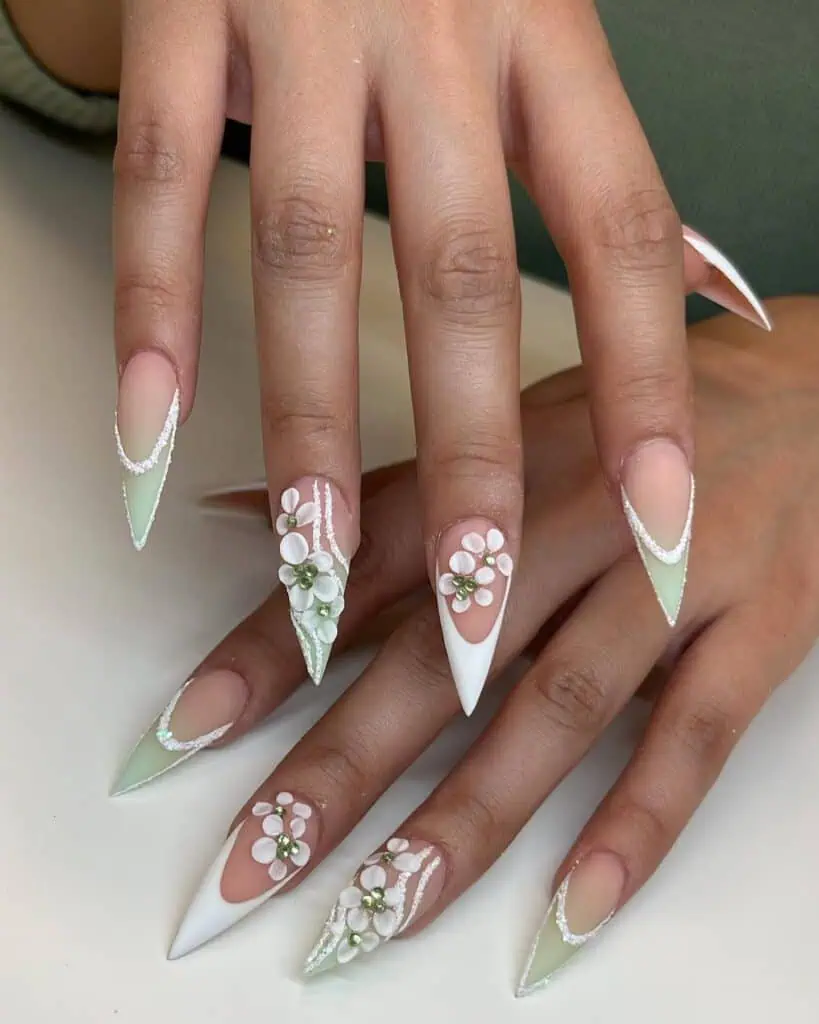 Vibrant springtime acrylic nails in soft pastel shades adorned with floral patterns, ideal for spring break.
