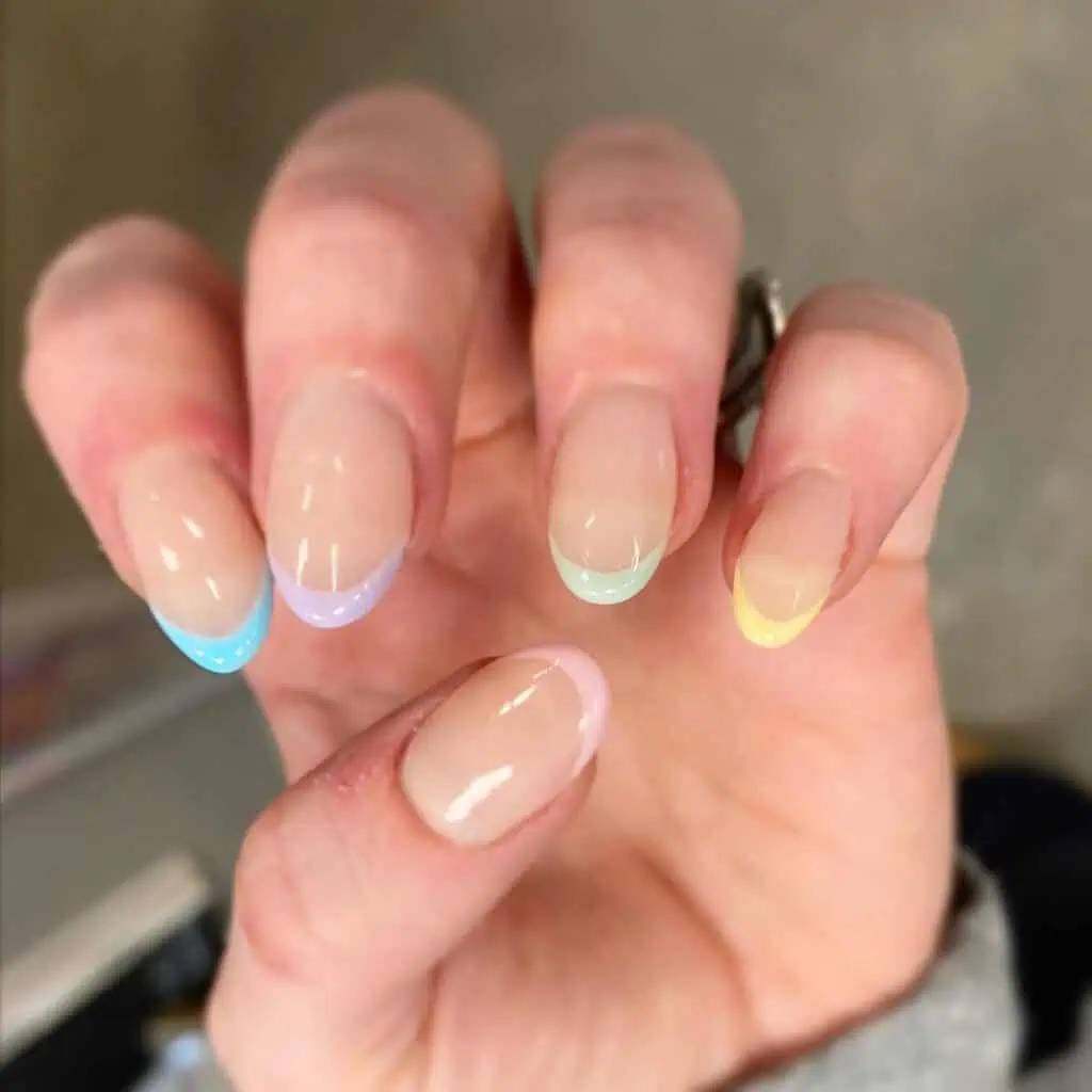 Spring French tip nails featuring a blend of pink and blue, capturing the essence of vibrant spring designs and seasonal colors.