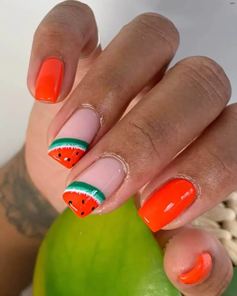 Cheerful watermelon nails with vivid summer shades of pink and green, highlighted by fun black seed accents, ideal for a refreshing summer style.