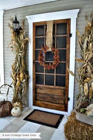 Vintage Fall Porch  with dried corn stalks, hay bales and fall wreath