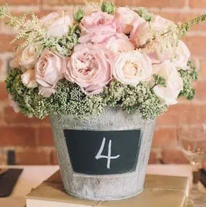 Blackboard Bucket Wedding Centrepiece - DIY Rustic Wedding Ideas are the perfect way to bring a sense of warmth, charm, and personalized touches to your special day. Whether you're planning a countryside celebration or simply want to incorporate the beauty of natural elements into your event, rustic wedding themes offer a timeless appeal that resonates with many couples.