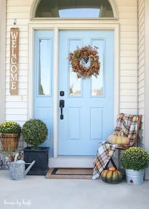 welcome sign for front door with mums on either side