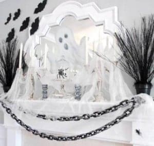 black and white Haunted Mantel with ghosts and chains 