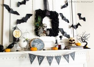 Burlap Halloween wreath above the mantel with spooky chalkboard garland