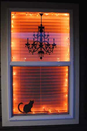 spooky halloween window with orange string lights